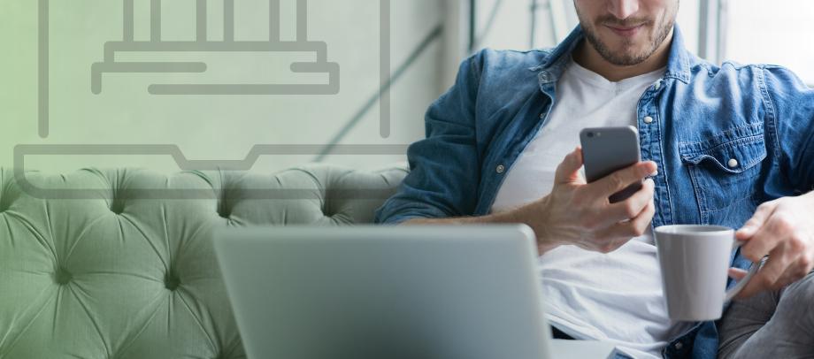 Man on couch looking at phone